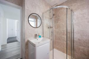 a bathroom with a sink and a shower at Seaside Bungalow with Garden & Inflatable Hot Tub in Hamworthy +27 photos