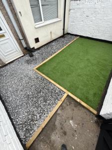 a yard with a green lawn next to a door at ResiLets Taylor House in Bebside
