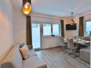 a living room with a couch and a dining room at Apartment in Piesendorf near Ski Slopes in Piesendorf