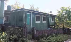 a green house with a fence in front of it at Noah Yourt in Siolim