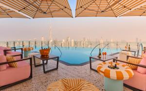 a view of a pool with pink chairs and tables at SLS Dubai Hotel & Residences in Dubai