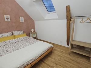 a bedroom with a bed and a skylight at Charmant Gîte 6 Pers avec Piscine Privée et Jardin, Avon-les-Roches - FR-1-381-629 in Avon-les-Roches +12 photos