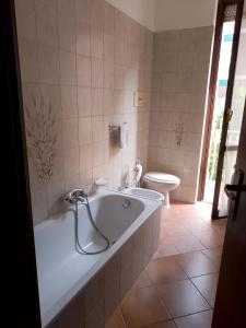 a bathroom with a tub and a toilet at Casafiorella in Monza