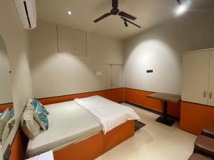a bedroom with a bed and a ceiling fan at Hotel Jain's Inn in Chhuīkhadān