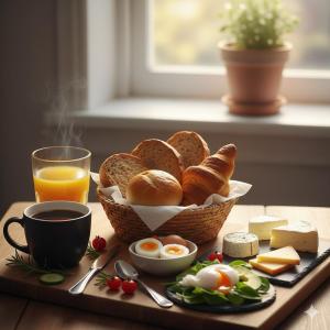 a tray of bread and eggs and a cup of orange juice at Winding B&B Silkeborg in Silkeborg