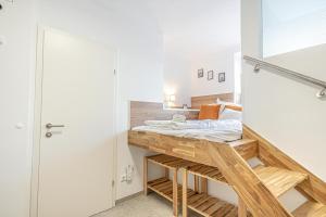 a bedroom with a bed and a wooden desk at Modern & Air condition 5BR, Near Danube River in Krems an der Donau