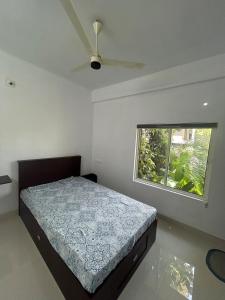 a bedroom with a bed and a window at Samriddhi Homestay in Trivandrum +112 photos