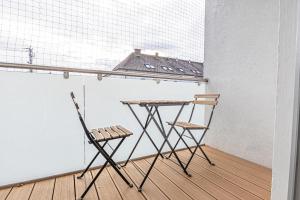 two chairs and a table in a room at Modern & Air condition 5BR, Near Danube River in Krems an der Donau