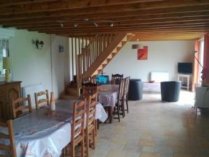 ein Esszimmer mit Tisch und Stühlen und einer Treppe in der Unterkunft Grande maison de campagne avec jardin, terrasse, accueil chevaux, proche plage de Wissant, animaux OK - FR-1-376-39 in Pihen-lès-Guînes + 7 Fotos