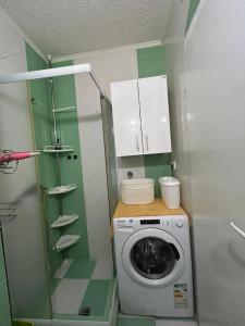 a small bathroom with a washing machine in it at Apartment with one bedroom in Kotor