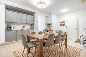 a kitchen and dining room with a wooden table and chairs at Modern & Air condition 5BR, Near Danube River in Krems an der Donau