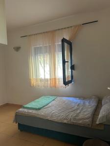 a bed in a room with a window at Apartment with one bedroom in Kotor