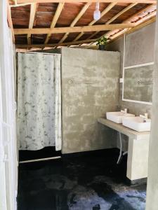 a bathroom with two sinks and a shower at Memo's Inn in Hiriketiya +38 photos