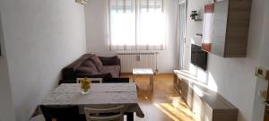 a living room with a table and a couch at Lux Apartmans in Zagreb