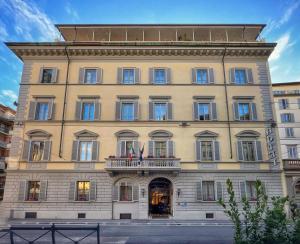 a large tan building with a balcony at Hotel De La Pace, Sure Hotel Collection by Best Western in Florence