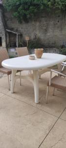 a white table with a bowl on top of it at Le Laoul cottage 2 people in Bourg-Saint-Andéol