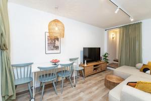 a living room with a couch and a table and chairs at Villa LaPetra in Cavtat
