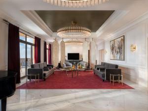 a large living room with couches and a television at Sofitel Cairo Downtown Nile in Cairo