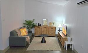 a living room with a couch and a table at Cosy Homes in Suva - 2BR Family Unit in Suva +5 photos