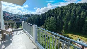 a balcony with a view of a mountain at Nishtha Homestay in Lohaghāt