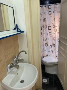 a bathroom with a sink and a toilet at Sami Apartments in Amman +53 photos