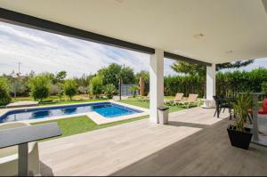 a house with a swimming pool and a patio at OLE TÚ ANDALUCIA in Sanlúcar la Mayor