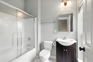 a bathroom with a toilet and a sink and a shower at New Listing Bulldog Borough in Downtown Athens in Athens +16 photos