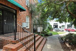 a brick building with a staircase in front of a door at New Listing Bulldog Borough in Downtown Athens in Athens