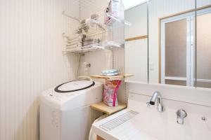 a laundry room with a washing machine and a sink at Tenjinbashi-suji Shopping Street Guesthouse Entire House Direct train access to 道頓堀 黒門市場 USJ Kansai International Airport in Osaka