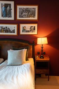 a bedroom with a bed and a table with a lamp at Steam Hotel in Västerås