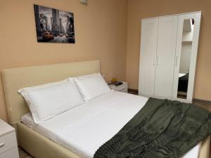a bedroom with a white bed and a mirror at Residence Principe di Saronno in Saronno +7 photos