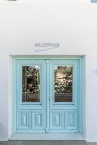 a blue door on the side of a building at Majo Suites Hotel in Agia Anna Naxos