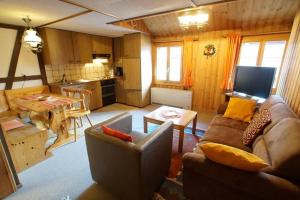 a living room with a couch and a table at Fewo Mit Blick Auf Die Berge in Sedrun