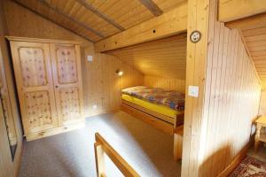 a small room with a bed in a cabin at Fewo Mit Blick Auf Die Berge in Sedrun +13 photos