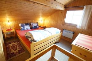a bedroom with a bed in a log cabin at Fewo Mit Blick Auf Die Berge in Sedrun +13 photos