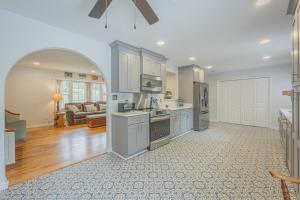an open kitchen and living room with an archway at Restful Riverside Residence w Firepit in Athens