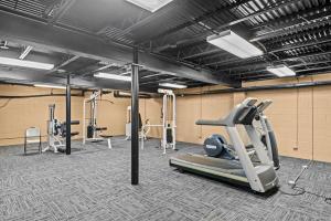 una palestra con tapis roulant e altre attrezzature sportive di Classic City Getaway - Walk to Sanford Stadium ad Athens