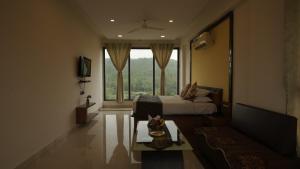 a bedroom with a bed and a large window at Hotel White Lotus in Dūngarpur
