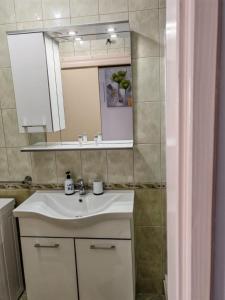 a bathroom with a white sink and a mirror at Apartment Seman in Vela Luka