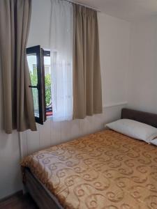 a bedroom with a bed and a window at Apartment Seman in Vela Luka