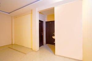 an empty room with yellow walls and a door at FabHotel Club Metro in Nagpur