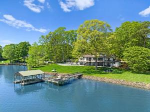 an aerial view of a lake with a dock at Fox Run w/Heated Pool & Optional Boat Rental in Westport