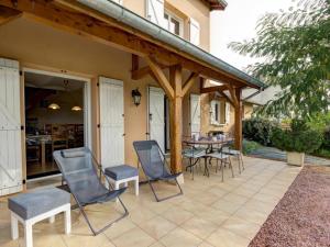 a patio with chairs and a table in a house at Gîte à Saint-Forgeux-Lespinasse avec Terrasse et Animaux Bienvenus - FR-1-496-37 in Saint-Forgeux-Lespinasse