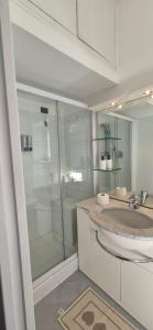 a bathroom with a glass shower and a sink at San Vincenzo C Rooms in Genoa