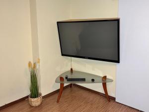 a flat screen tv hanging on a wall at Apartament Jośki in Rybnik
