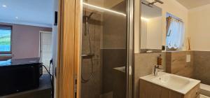 a bathroom with a shower and a sink and a sink at Ca del Tusa in Livigno +17 photos