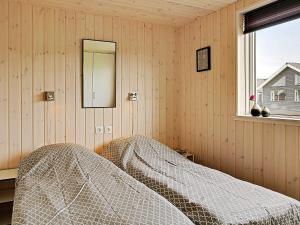 a bedroom with a bed and a mirror and a window at 5 star holiday home in Kappeln in Kappeln