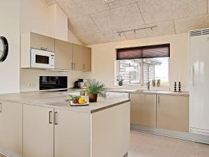 a kitchen with white cabinets and a counter top at 5 star holiday home in Kappeln in Kappeln +18 photos