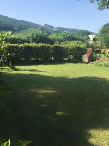 a large field of grass with a large shadow at La Maison de Campagne in Estalane +5 photos