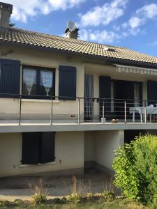 a house with a balcony with a table on it at La Maison de Campagne in Estalane